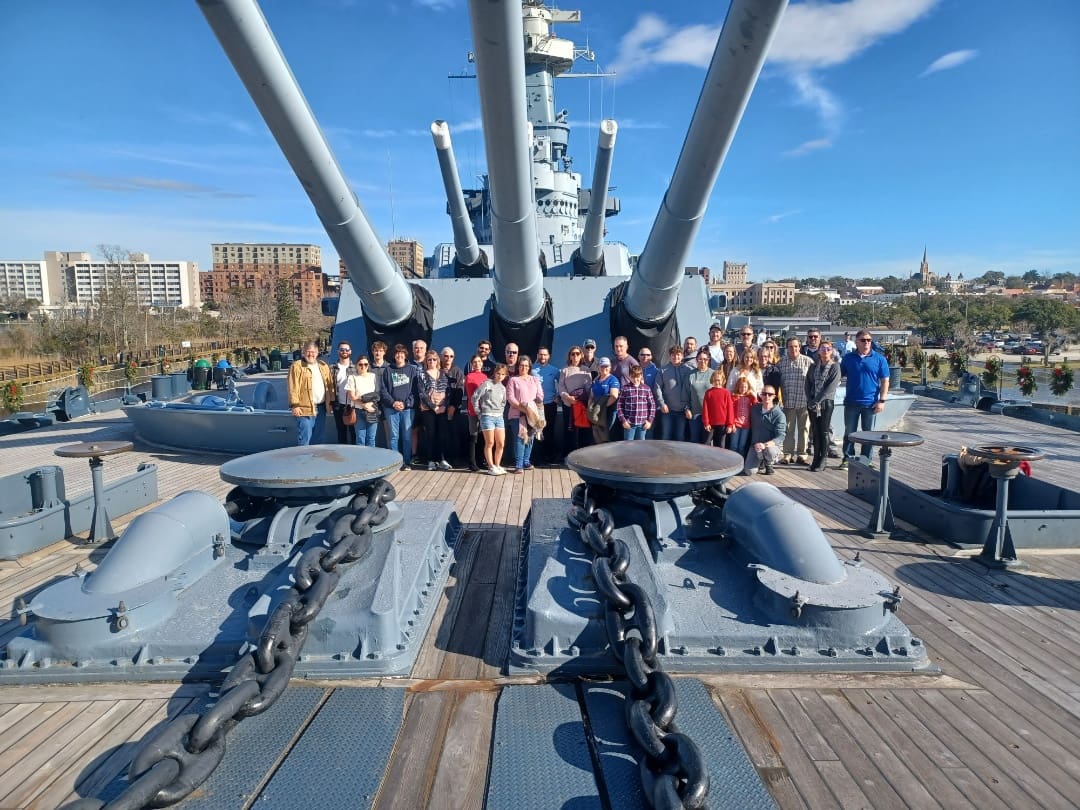 Large group on battleship deck.